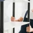 Fatboy Slims Moving Company | Blog Two workers in uniforms assemble a white shelf against a white brick wall.