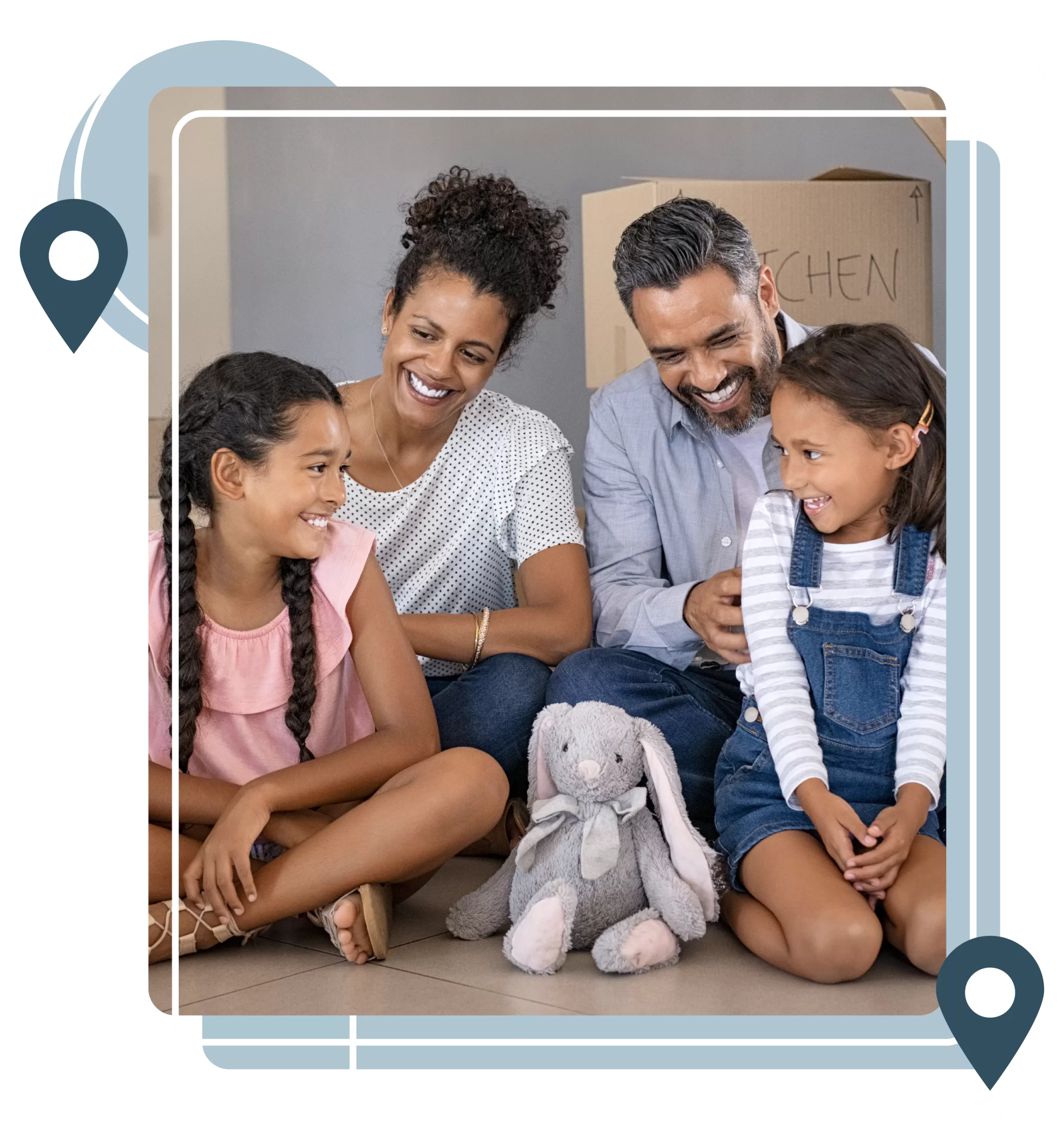 Family sitting on the floor, smiling at one another, with a stuffed bunny toy in front of them. Moving boxes labeled "Kitchen" are in the background.