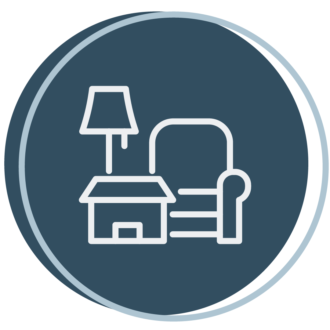 Icon of a living room setting with a chair, lamp, and house symbol on a dark blue circular background.
