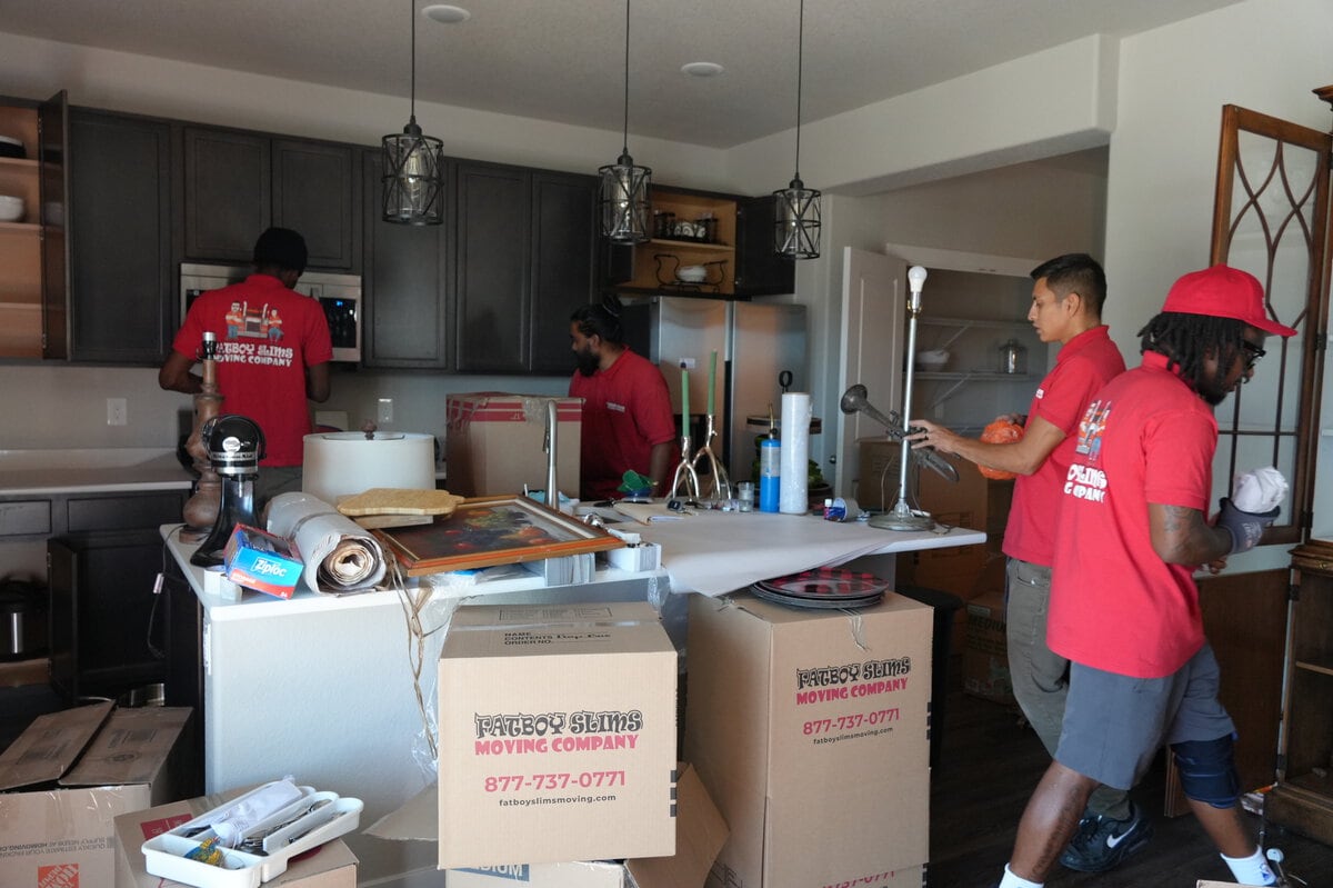 Fatboy Slims Moving Company crew packing items in a kitchen