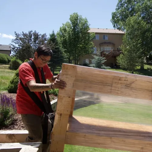 Fatboy Slims Moving Company mover carefully handling a large wooden furniture piece.