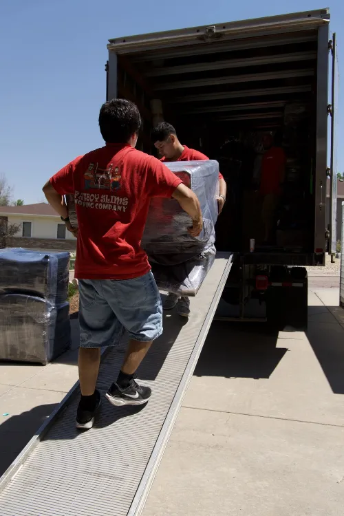 Fatboy Slims movers loading wrapped furniture into a moving truck in Colorado Springs.