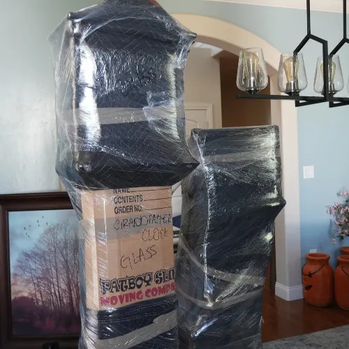 Furniture and household items wrapped and protected by Fatboy Slims Moving Company.