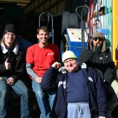 Fatboy Slims Moving Company team posing together beside moving equipment.