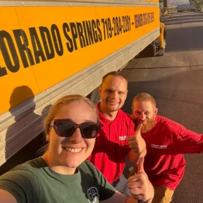 Fatboy Slims Moving Company team beside a moving truck in Colorado Springs.