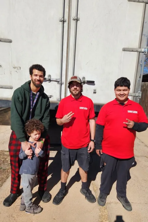 Fatboy Slims Moving Company team posing together in front of a moving truck.