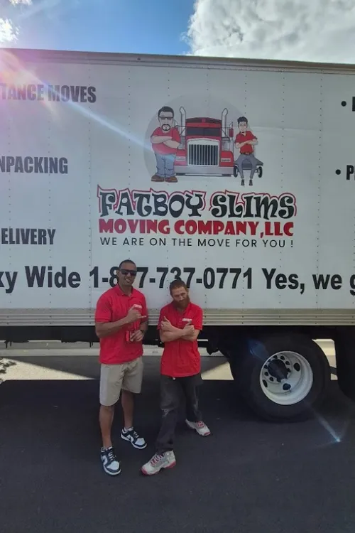 Fatboy Slims Moving Company team standing beside a branded moving truck.